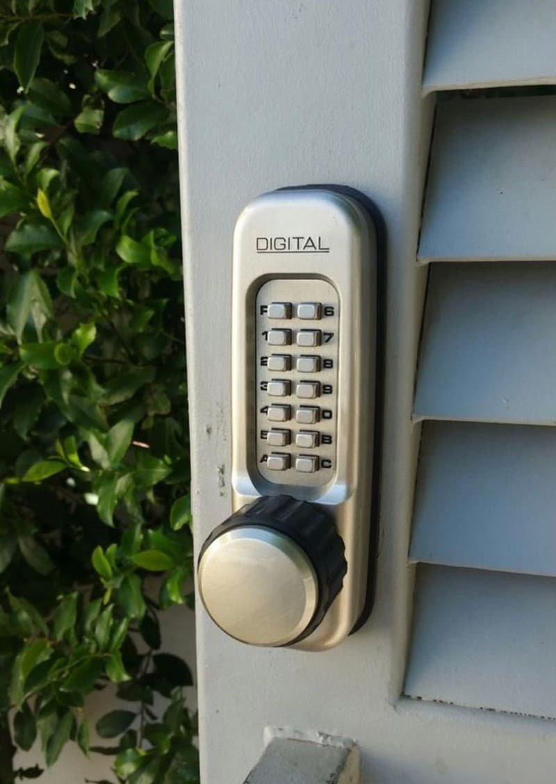 Mechanical DIGITAL keypad lock on an outdoor gate — keyless, no batteries