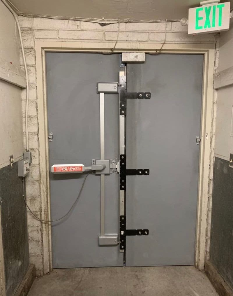Heavy-duty commercial panic bar and multi-point locking on gray double doors
