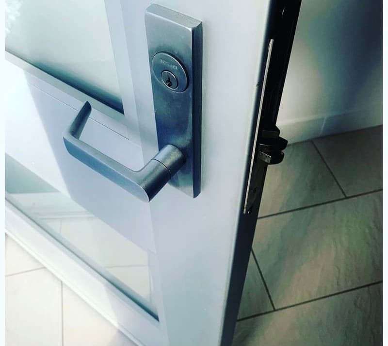 Schlage commercial lever and lock cylinder on a glass storefront door