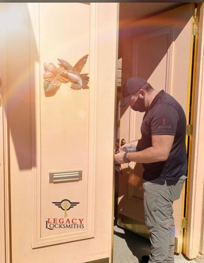 Mobile locksmith working on a residential front-door latch